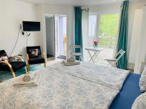 a bedroom with a large bed and a large window at Bed and Breakfast 57 in Asuel