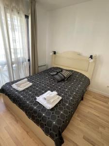 a bedroom with a bed with two towels on it at Luxury Gated Apartment in Sofia
