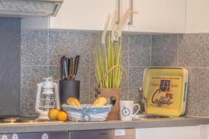 a kitchen counter with a bowl of bread and a yellow box at Ferienhaus Ostsee in Pruchten