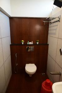 a small bathroom with a toilet and a sink at Canyon sun in Chennai