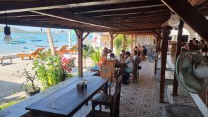 a group of people sitting at a table at a restaurant at Spear Villa in Bumbang