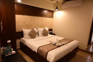 a bedroom with a bed with white sheets and pillows at Canyon sun in Chennai