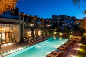 a swimming pool with lounge chairs and a building at Arts Hotel Bodrum Yalikavak in Yalıkavak