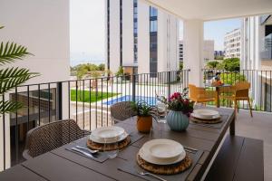 a table with plates on it on a balcony at NIU Line - Be Line Group in Villajoyosa +178 photos