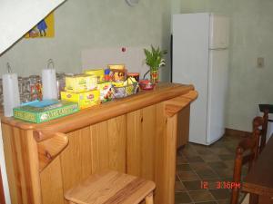 a counter with food and a refrigerator in a kitchen at Chambre Périgourdine in Beynac-et-Cazenac