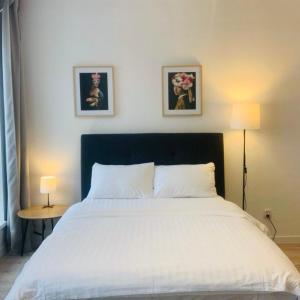 Platon Residence Apartments في لودز: غرفة نوم بسرير وصورتين على الحائط