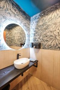 a bathroom with a sink and a mirror at Hotel San Lorenzo in Santiago de Compostela