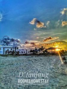 a sunset on a beach with the words at D' Tanjung Homestay-Orked in Pekan