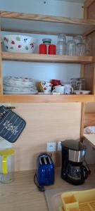 a kitchen with a coffee maker on a shelf at Chalet in Savières