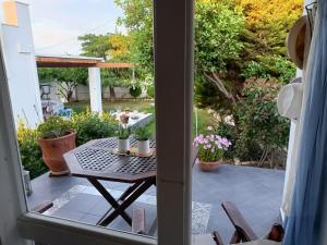 a view from the door of a patio with a table at Casa Martina 2 (Spata) 10min El.Venizelos airport. in Spáta +28 photos