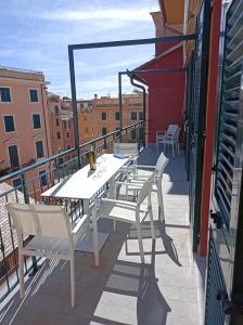 a table and chairs on the balcony of a building at Miramare Suites in Sestri Levante