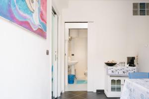 a white bathroom with a painting on the wall at Stop And Go in Scilla +41 photos