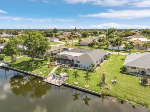an aerial view of a house on the water at Cozy Retreat, heated pool, water canal, bikes,3 bedroom in Cape Coral