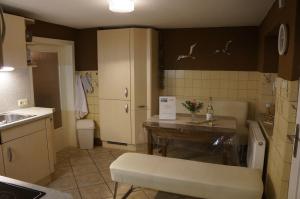 a small kitchen with a table and a sink at Dat Reethus Grambin in Grambin