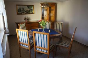 a dining room table with chairs and a vase of flowers on it at Dat Reethus Grambin in Grambin