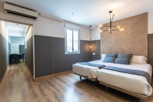 Łóżko lub łóżka w pokoju w obiekcie Suites You Zinc