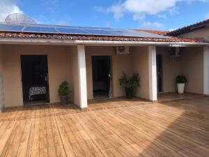 a porch of a house with a wooden deck at Pousada Kactus in Piranhas