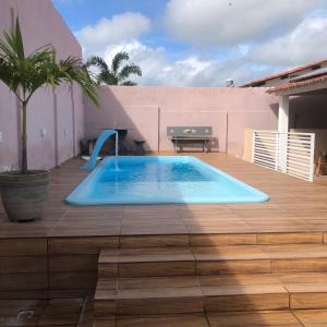a swimming pool on top of a wooden deck at Pousada Kactus in Piranhas