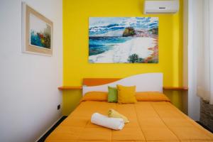 a bedroom with a bed with a yellow wall at Stop And Go in Scilla