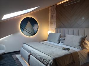 a bedroom with a bed and a round mirror at Miramare Suites in Sestri Levante