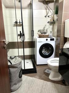a bathroom with a washing machine and a toilet at Panama apartment in Ulcinj