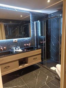 a bathroom with a sink and a glass shower at Miramare Suites in Sestri Levante