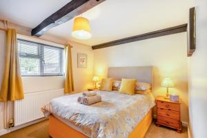 a bedroom with a large bed and a window at The Old Dairy & The Old Stables in Thetford
