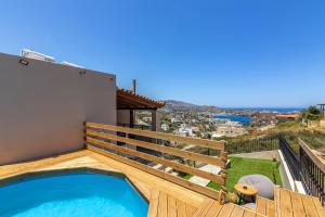 a swimming pool on the deck of a house at Aegean Sunset Luxury Penthouse in Lygaria