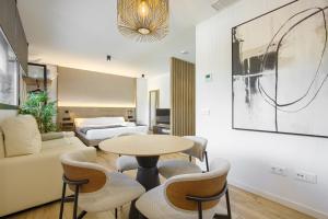 a living room with a table and chairs and a couch at Arena 20 Suites in Valencia