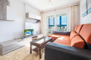 a living room with a couch and a tv at Acintur 13-A Apartment Levante Beach-Old Town in Benidorm