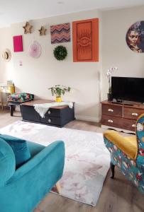 a living room with a couch and a tv at Unboring Holiday Let, Ballina, Mayo in Ballina
