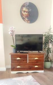 a television on a dresser in a living room at Unboring Holiday Let, Ballina, Mayo in Ballina