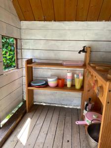 a shelf in a wooden cabin with plates and dishes at Il Nido della Buonanotte 2 pet friendly in Verona