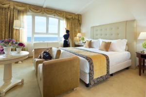 a hotel room with a large bed and a window at Hotel De Londres in Rimini