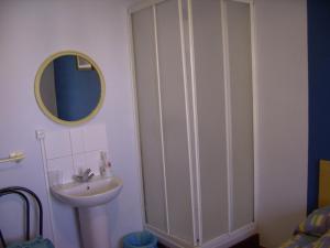 a bathroom with a sink and a mirror at Pensión Gema in Irún