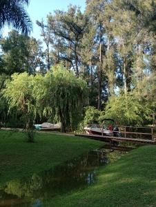 a boat on a river in a park at Cabaña ALUMCO in Tigre +8 photos