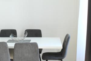 a dining room table with chairs and a white table at Home Sweet Home - Leopold in Vienna