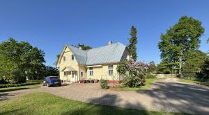 a house with a car parked in a driveway at Peaceful summer house - Sunshine in Jūrmala +19 photos