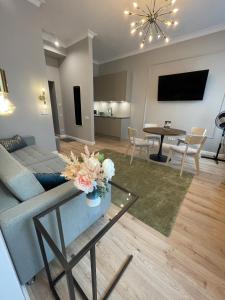 a living room with a couch and a table at Aparthotel Amella in Rīga