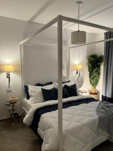 a bedroom with a white bed with a canopy at Villa Marina in Marina dʼAndora