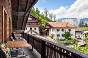 a balcony with a view of a village and mountains at Ferienwohnung Piburgersee in Oetz