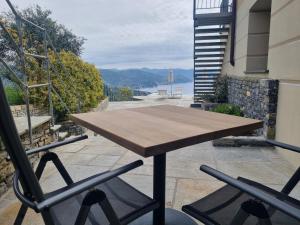 a wooden table and two chairs on a balcony at Il Leccio - Luxury Resort Portofino Monte in Santa Margherita Ligure