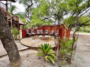 a patio with chairs and a fire pit in front of a house at Zaganaga Kruger Lodge in Marloth Park