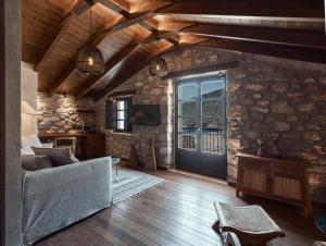 a living room with a couch and a door at KaSeas Boutique Hotel in Gerolimenas