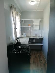 a kitchen with a stove top oven in a room at Mayors Rest on 44 in Uniondale