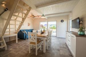 a kitchen and dining room with a table and chairs at Pod Morskim Niebem in Rowy