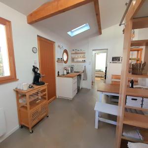 a kitchen with a table and a counter top at Sous deux chênes in Vieux-Boucau-les-Bains +14 photos