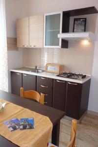 a small kitchen with a table and a stove at Stanze Ad Est in Ragusa