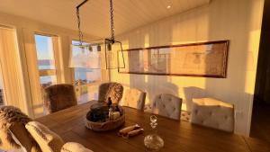 a dining room with a wooden table and chairs at Superior Wildlife Chalet Lofoten in Napp