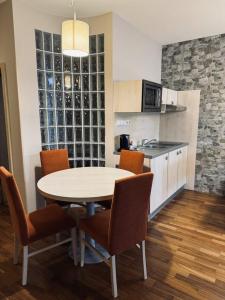 a kitchen with a table and chairs in a room at Hotel Crocus in Vysoke Tatry - Strbske Pleso